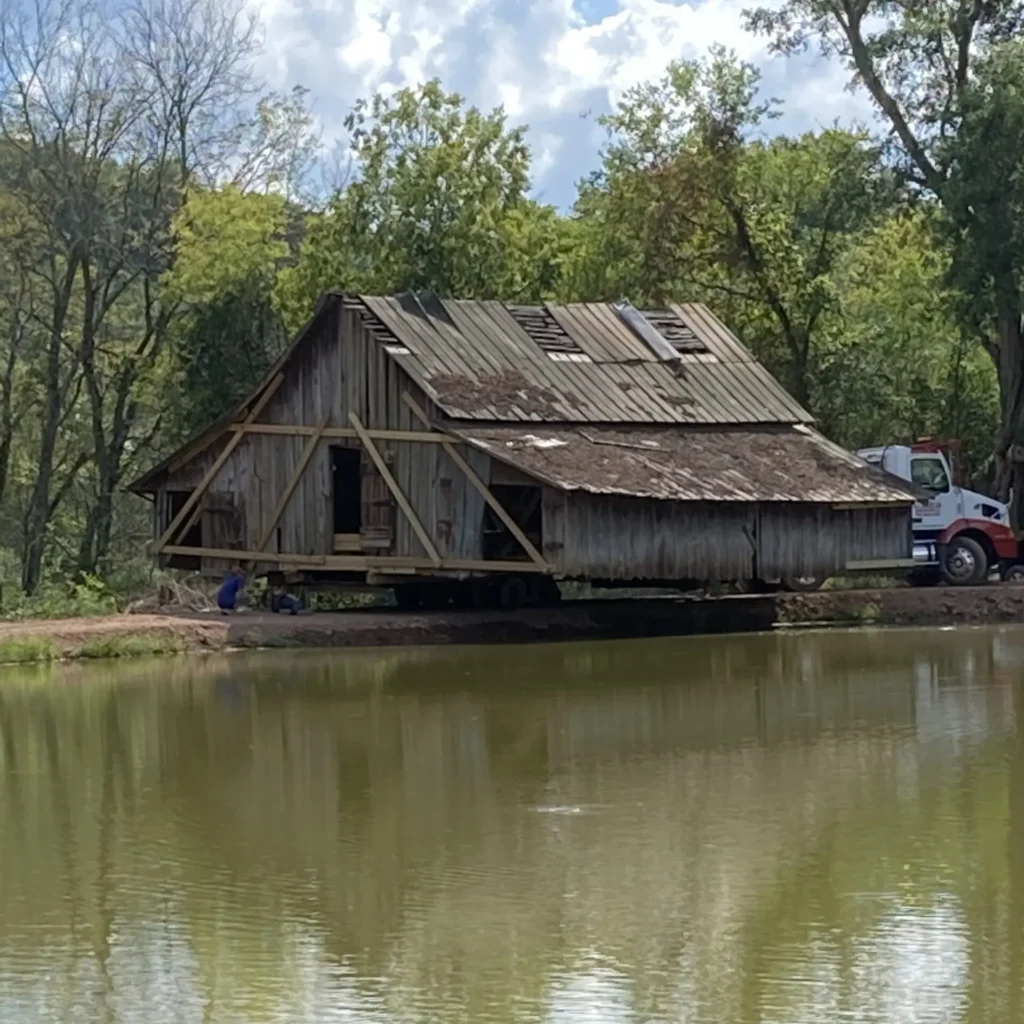 Moving an old barn by a lake.